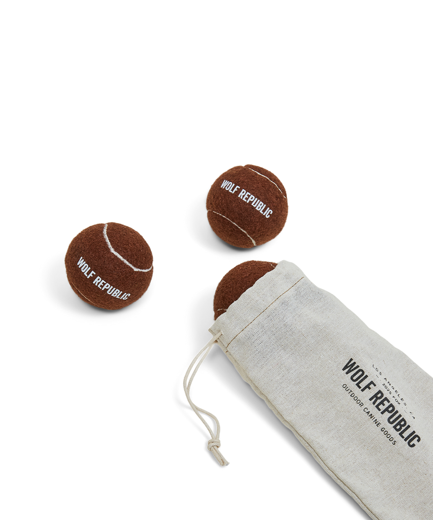 set of three brown tennis balls with logo