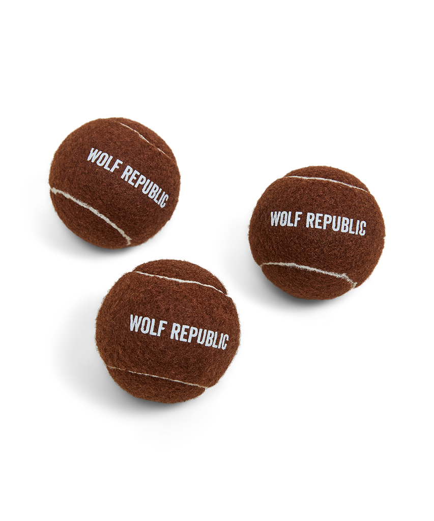 set of three brown tennis balls with logo