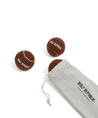 set of three brown tennis balls with logo